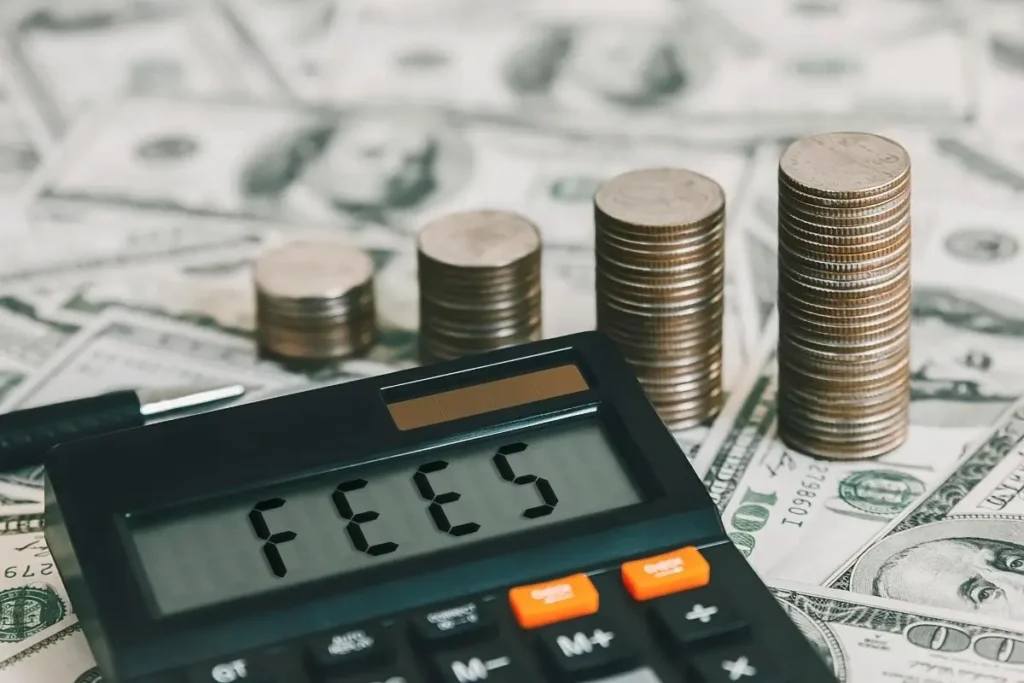 A calculator on dollars and fees written on calculator display. 